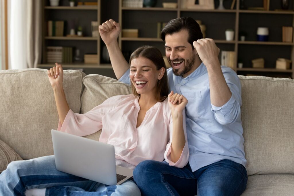 Couple celebrating after learning about accessing annuity payments and available financial options.