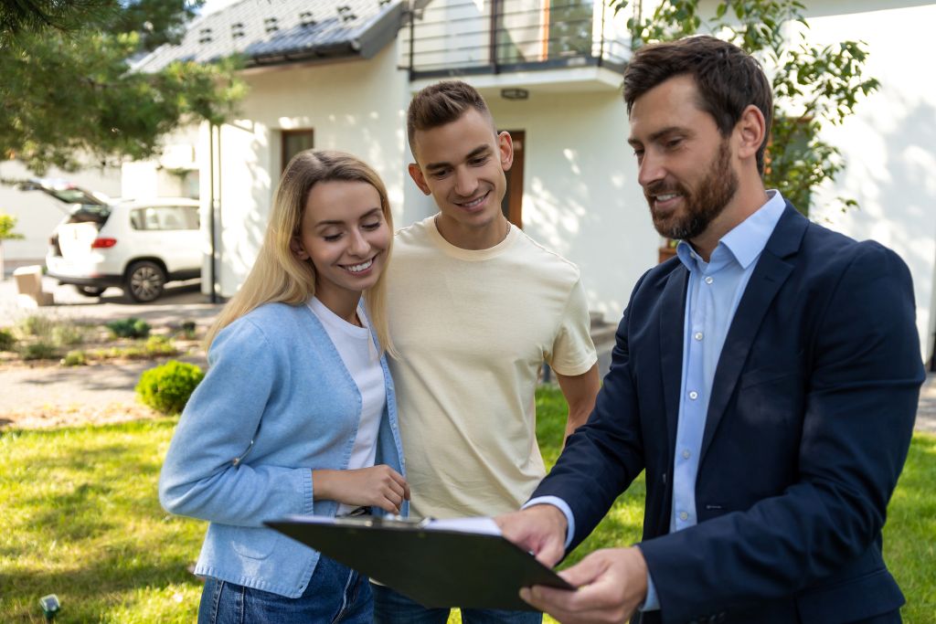 couple reviewing property purchase planning documents with agent